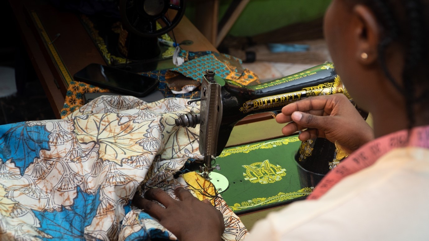 photo of a woman who is sewing taken from the back in order to hide her identity