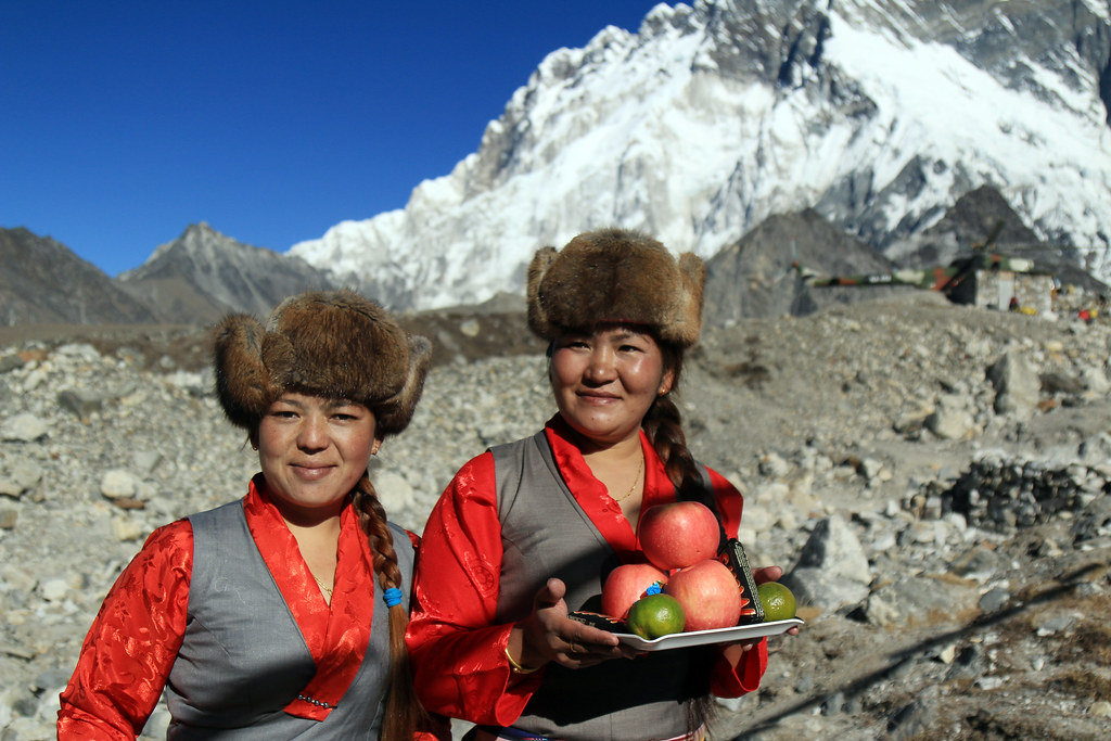 Two women with fur hats standing on mountain top in Nepal 